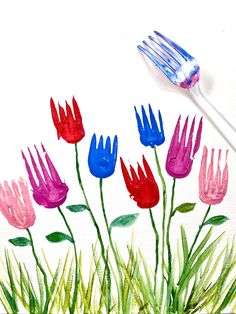 a painting of flowers and a fork with watercolors on the paper behind it