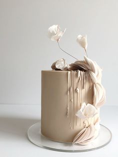 a white cake with icing and flowers on top