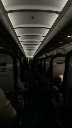 the inside of an airplane with people sitting in it