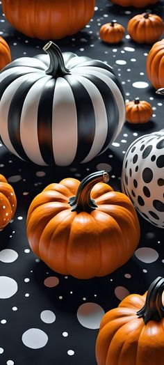 many pumpkins and polka dots on a black surface