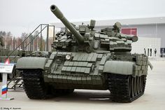 an army tank sitting on top of a parking lot