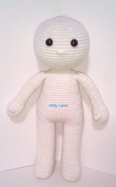 a crocheted white teddy bear with black eyes