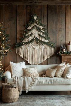 a living room filled with furniture and christmas tree hanging on the wall above it's headboard