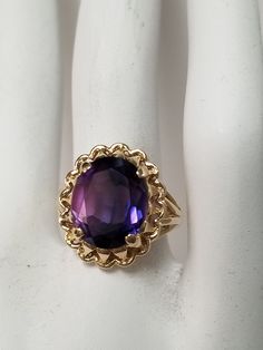 "Thanks for shopping our vintage estate store. We tend to sell well below wholesale and truly hope you enjoy all of our items. Many of the items are one of a kind, so please enjoy scrolling through the pictures and hopefully something will catch your eye. Brown spots are from camera or reflections. Estate 10k yellow gold purple blue 5ct sapphire cocktail filigree ring. Gem is testing natural, more than likely created, beautiful gem. Ring size: 5.5 Setting: 12mm 5/8\" Gem: 10mm by 12mm 5cts Band Vintage Amethyst Ring With Accent Stones For Collectors, Vintage Amethyst Ring With Accent Stones, Vintage Gold Amethyst Birthstone Ring, Estate Style Collectible Gemstone Jewelry, Estate Style Round Jewelry Gift, Estate Oval Jewelry For Gifts, Vintage Oval Amethyst Birthstone Ring, Vintage Birthstone Ring With Accent Stones As Gift, Vintage 14k Gold Amethyst Ring With Accent Stones