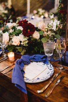 the table is set with flowers and candles