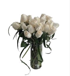 a vase filled with white roses on top of a table