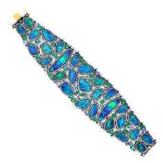 A stunning bracelet cuff is handmade in 18K gold and sterling silver. It is set in 7.97 carats emerald, 57.12 carats opal doublet, 7.42 carats tanzanite and 7.27 carats diamonds. Pair this with your favorite evening dress for a red carpet look. Clasp Closure FOLLOW MEGHNA JEWELS storefront to view the latest collection & exclusive pieces. Meghna Jewels is proudly rated as a Top Seller on 1stDibs with 5 star customer reviews. All items manufactured by us are handmade and can be customized or rede Diamond Cuff Bracelet, Gems Bracelet, Sparkly Jewelry, Tanzanite Diamond, Bracelet Cuff, Diamond Bangle, Gold Jewellery Design, Gemstone Bracelets, Opal Jewelry