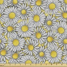 a yellow and white flower pattern on a gray background with a ruler in the foreground