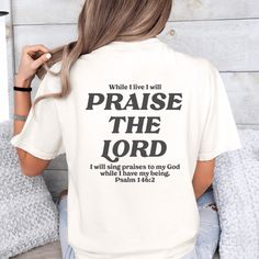 This Praise the Lord t-shirt with Psalm 146:2 Bible verse on the back is a great way to proclaim your faith! Trendy Christian graphic tees like this Praise The Lord shirt can make a bold statement in sharing your love for the Lord and serve as a reminder to Praise Him in all you do! Plus, it's a great way to share God's word and plant seeds of faith anywhere you go! This cute Christian t-shirt is versatile to create a cool Christian street style with sweats or joggers. Or size up and pair it wit Jesus Merch, Bible Verse Shirts, God Shirts, Worship Night, Christian Graphics, Christian Graphic Tees, Bible Shirts, Praise Him, Praise The Lord