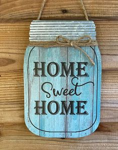 a wooden sign hanging on the side of a wall that says, home sweet home