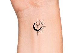 the sun and moon tattoo is on someone's wrist