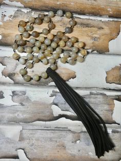 Hand knotted leather and beaded long necklace. Boho Vibe Necklace. A fun pendant and the perfect gift for that eclectic friend. I T E M ∙ S P E C I F I C A T I O N S - NECKLACE: 36" in length, Natural suede leather tassel measures 6" long, beads are about 3/8" round - RHINESTONE: Aprox. 62 beads C A R E ∙ T I P S We don’t want your special moment to fade. To maintain the quality of your jewelry, please: - Do not wear it to the pool, spa, or the beach - Remove when sleeping, exercising, or doing Handmade Adjustable Brown Tassel Necklace, Brown Tassel Necklaces As Gifts, Adjustable Brown Hand Knotted Necklaces, Brown Adjustable Hand Knotted Necklace, Adjustable Long Spiritual Tassel Necklace, Adjustable Brown Hand Knotted Beaded Necklace, Adjustable Brown Hand-knotted Beaded Necklace, Adjustable Hand Knotted Brown Beaded Necklace, Beaded Leather Necklace