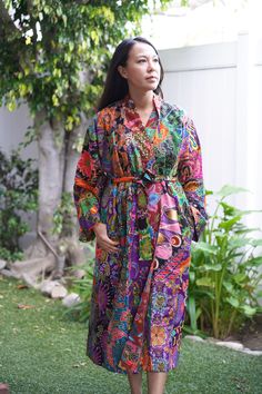 This is a long washable printed batik robe/ kimono handmade by artisans, thick duster and home jacket. Eco-friendly, upcycled fabric for conscious fashion. The fabric was sourced from surroundings clothing manufacturer that would have been otherwise discarded. Because of the upcycled material and handmade nature of this item, each batik quilt kimono is not alike. The print will be of slightly different pattern and color but in variation of black, blue, pink, purple, green mix pattern. This thick Cotton Kimono With Batik Print And Long Sleeves, Bohemian Cotton Kimono With Batik Print, Quilt Kimono, Multicolor Cotton Robe For Festival, Kimono Batik, Multicolor Cotton Kimono With Batik Print, Multicolor Long Cotton Robe, Bohemian Cotton Robe With Floral Print, Long Multicolor Cotton Robe