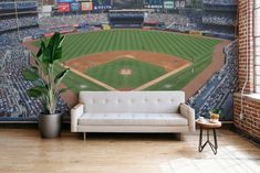 a living room with a couch and baseball field wall mural