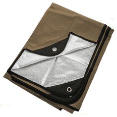 an open brown and black bag on top of a white surface with the bottom folded up