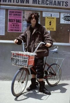 a man standing next to a bike with a basket