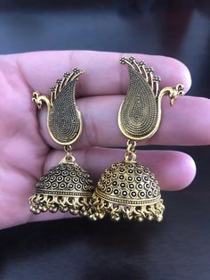 Be unique and make an impact by looking stunning with this antique oxidized peacock earrings with hanging jhumkis made with love💕 for someone special! In stock and ready to ship. Hand crafted and gold plated kundan indian/pakistani jewelry Material:brass,stone,gemstone,pearl We bring you casual as well as party wear jewelry which comes with an attractive design and style. It goes well modern and traditional outfits. Visit my website for more collections https://www.etsy.com/shop/Noorzaracollect Brass Chandbali Jhumkas With Intricate Design, Bohemian Drop Jhumkas In Metal, Bollywood Brass Chandbali Jhumkas, Bollywood Brass Jhumkas With Intricate Design, Bollywood Style Brass Jhumkas With Intricate Design, Bollywood Style Brass Chandbali Jhumkas, Bohemian Brass Jhumkas For Weddings, Bohemian Jhumkas With Intricate Design, Bohemian Brass Chandbalis For Festive Occasions