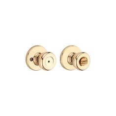 two golden door knobs on a white background