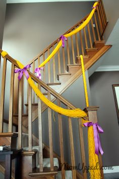 a staircase decorated with yellow and purple ribbons