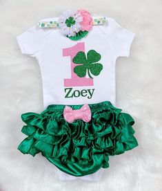 This listing is for Baby girl's Irish -St Patrick's theme First Birthday outfit . Includes Bodysuit, Bloomerskirt (ruffles all around )and headband . Name can be added on the bodysuit. Please leave a note in the note to seller box upon checkout for personalization. Bodysuit used is carter's brand . Carter's Bodysuit is Crafted in babysoft cotton, Easy to change with Nickel-free snaps on reinforced panels . All outfits are made to Order and Normal PROCESSING time is 2 weeks. *Processing time DOES First Birthday Fitted Sets With Ruffles, Cute Ruffled Sets For First Birthday, Cute Ruffled Sets For Birthday, Fitted Birthday Sets With Ruffles, Cute Diaper Cover For First Birthday, White Ruffled Birthday Set, Fitted Sets With Ruffles For Birthday, White Ruffled Sets For Birthday, White Ruffled Set For Birthday