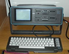 an old fashioned computer sitting on top of a wooden desk