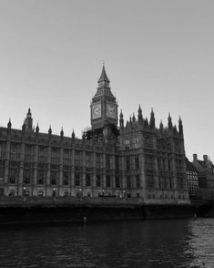 the big ben clock tower towering over the city of london, england in black and white