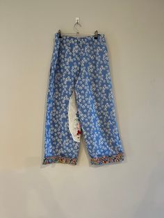 These georgeous size 10 retro trousers were on of my favourite things to make.  The trousers are a very relaxed style with wide legs for comfort.  The pants are created from a preloved retro sheet and a vintage soily I have loved and collected over time.    The trousers feature an elasticised waist band for comfort and fit.   They feature generous inseam pockets and I was able to feature the vintage doily I loved - to cover a little fault in the preloved fabric.   The trouser legs are finished with a retro fabric for the cuffs  The pants are a relaxed style to comfortably fit  on Hips:  85-89cm, Waist:  63-67cm,  The trousers are priced at $69.00 with free delivery in Australia. Straight Leg Cotton Bottoms For Pajama Party, Cotton Straight Leg Pajama Bottoms, Cotton Straight Leg Pajama Party Bottoms, Cotton Straight Leg Bottoms For Pajama Party, Cotton Straight Pants For Pajama Party, Cotton Wide Leg Bottoms For Pajama Party, Retro Cotton Wide Leg Pants With Pockets, Retro Wide Leg Cotton Pants With Pockets, Vintage Ankle-length Cotton Pants