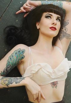 a woman with tattoos on her arms and chest