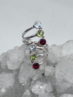 Multi-Gemstone Ring, Size -Various Adjustable Garnet, Peridot, and Blue Topaz 925 Sterling Silver WWW.KARINSFORGOTTENTREASURES.COM Silver Stackable Rings With Gemstone Accents, Round Multi-stone Gemstones For May Birthstone, Sterling Silver Ruby Ring With Gemstone Accents, Multi-stone Round Jewelry For May Birthstone, Green Multi-stone Round Topaz Ring, Green Multi-stone Topaz Ring, Stackable Blue Topaz Round Rings, Blue Topaz Rings With Stones, Stackable Round Blue Topaz Rings