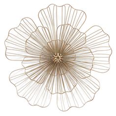 a gold metal flower decoration on a white background