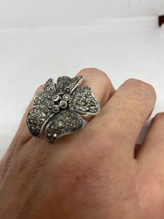 Vintage ring surrounded by Swiss cut fine Marcasite Sterling silver Size 6 can be sized by my jeweler. His service charge is $10-$20 All rings are shipped in a nice gift box. Check out our over a THOUSAND great reviews Engraving is $4 per letter and is not always perfect depending on the piece. It can take a few days if the jeweler is busy. This is payable to Paypal Judithsltd@gmail.com Vintage Silver Flower Ring Gift, Vintage Silver Flower Ring For Gift, Silver Vintage Flower Ring For Gift, Vintage Silver Flower Ring For Jewelry Making, Silver Flower Ring Stamped 925 As Gift, Silver Marcasite Ring With Gemstone, Marcasite Ring For Anniversary, Marcasite Rings Stamped 925 As A Gift, Marcasite Sterling Silver Rings For Gifts