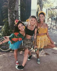 three women in costumes posing for the camera