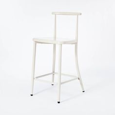 a white chair sitting on top of a white floor