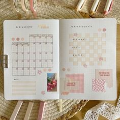 an open planner book sitting on top of a table next to some scissors and other items