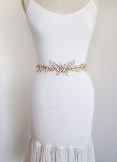 "This delicate romantic belt is made with Swarovski crystals twisted into this intricate design. This belt measures about 14\" long and 2 1/2\" wide in the center. It is attached to sheer organza ribbon measuring 3/8\" wide and 150\" long. This belt is available in gold, silver or rose gold finish." Elegant Gold Bridal Accessories With Sashes, Gold Embroidered Belt Sash For Parties, Elegant Gold Sashes With Embroidered Belt, Gold Embroidered Sash For Party, Elegant Adjustable Gold Belt, Gold Crystal Embellished Headpieces For Wedding, Gold Embroidered Belt For Party, Gold Embroidered Party Belt, Adjustable Bridal Belt With Sashes For Party