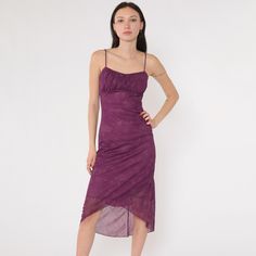 Vintage Y2K purple midi dress by Taboo featuring a ruched bust and spaghetti straps. The dress has a bodycon fit with an asymmetrical hemline and a sheer floral glitter overlay. Fully lined with a back zipper closure. Made in the USA, size small. Please see measurements and condition below. Every garment we sell is authentic vintage and one-of-a-kind! You will receive the exact item photographed. Condition: Very good vintage with light general wear. Size label: Labelled Small Tag: Taboo Material: self 100 Polyester lining 100 Polyester Era: y2k MEASUREMENTS Taken from seam to seam while the garment is lying flat. Double the armpit, waist, and hips For reference, model is 5'7" and measures 31-24-34. Length from Top: 46" Armpit to Armpit: 15 to 17" Waist: 13 to 14" Hips: 19" For sales and pr Glitter Overlay, Purple Midi Dress, Sheer Overlay, Dress Spaghetti, Size Label, Asymmetrical Hem, Floral Midi Dress, Spaghetti Strap Dresses, Dress Clothes For Women