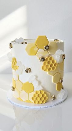 a white and yellow cake with honeycombs on it