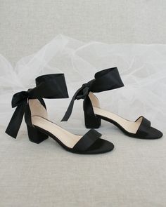 "Classy satin block heel with satin ribbon ankle tie. Simple yet elegant are great combination and will definitely be a favorite. DETAILS: FIT: RUNS LARGE, ORDER ONE SIZE DOWN HEEL HEIGHT: 1.5 inch (Kids) & 2 inches (Women) RIBBON WIDTH: 1.5 inches COLORS AVAILABLE: Black, Burgundy, Champagne, Ivory, Navy, White, Light Blue, Soft Blush UPPER: Synthetic upper and lining MATERIALS: Mandmade outsole STYLE NAME: NAOMI KIDS SIZES: Size 11- 7.65 inch Size 12 - 7.85 inch Size 13 - 8.15 inch Size 1 Black Bridesmaid Shoes, Bridesmaids Shoes, Kids Heels, Satin Noir, Holiday Shoes, Short Heels, Bridal Heels, Bridesmaid Shoes, Womens Wedding Shoes