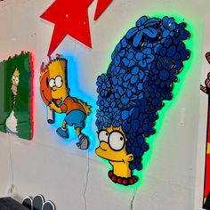 the simpsons characters are painted on the wall next to other cartoon character artwork and decorations