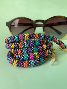 The perfect accessory for your wardrobe, adding a finishing touch to your outfit. Multi-functional glasses, sunglasses and mask chain holder with multi-colored beads. It can also be used as a necklace. Thank you in advance for choosing my designbycolla store. If you have a question, I can answer immediately. My three-functional product, which can be eyeglass chain, necklace, bracelet, is completely made with the help of handmade crochet. This eyeglass chain can be a very perfect choice for your Resizable Multicolor Jewelry Fashion Accessory, Resizable Multicolor Jewelry For Fashion, Colorful Beads Glasses Chains As Summer Gift, Summer Glasses Chains With Colorful Beads As Gift, Multicolor Beaded Chain Glasses Chains For Gifts, Multicolor Beaded Glasses Chain As Gift, Multicolor Beaded Glasses Chain For Gift, Adjustable Beaded Necklace With Lobster Clasp For Summer, Multicolor Adjustable Beaded Necklace