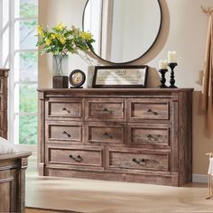 a bedroom with a dresser and mirror in it