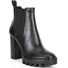 a pair of black leather boots with chunky soles on the bottom and heel