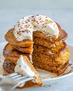 a stack of pumpkin pancakes with frosting on top and the words, healthy & fluffy pumpkin pancakes