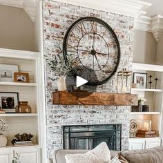 a living room filled with furniture and a large clock on the wall above a fireplace