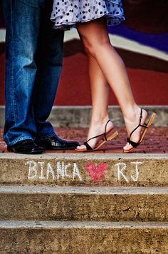 a man and woman standing on steps with their feet in each others's shoes