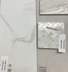 some white marble tiles and tags on the wall