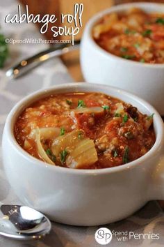 two white bowls filled with cabbage soup on top of a table