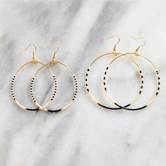 You asked for bigger beaded hoops and Libby & Smee answered! These dangly hoop earrings are the pieces you'll grab every day when you want a little something fun without a lot of fuss. Bonus: They look great dressed up or super casual. + style name: MONOCHROME+ beaded hoops with tiny glass black, cream and gold Delica beads+ gold-plated stainless steel ear wire hooks and beading wire (lead-free and nickel-free)+ comes with plastic earring back for security+ available in two large sizes: BIG, Black And White Beaded Earrings, White Beaded Earrings, Bead Looming, Boho Wedding Earrings, Stick Earrings, Plastic Earrings, Earrings Big, Long Tassel Earrings, Mini Hoop Earrings