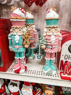 two nutcracker figurines are sitting on a shelf in a store with other christmas decorations