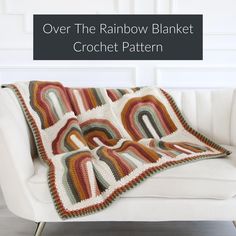 a white couch with a crocheted blanket on top of it and the text over the rainbow blanket crochet pattern